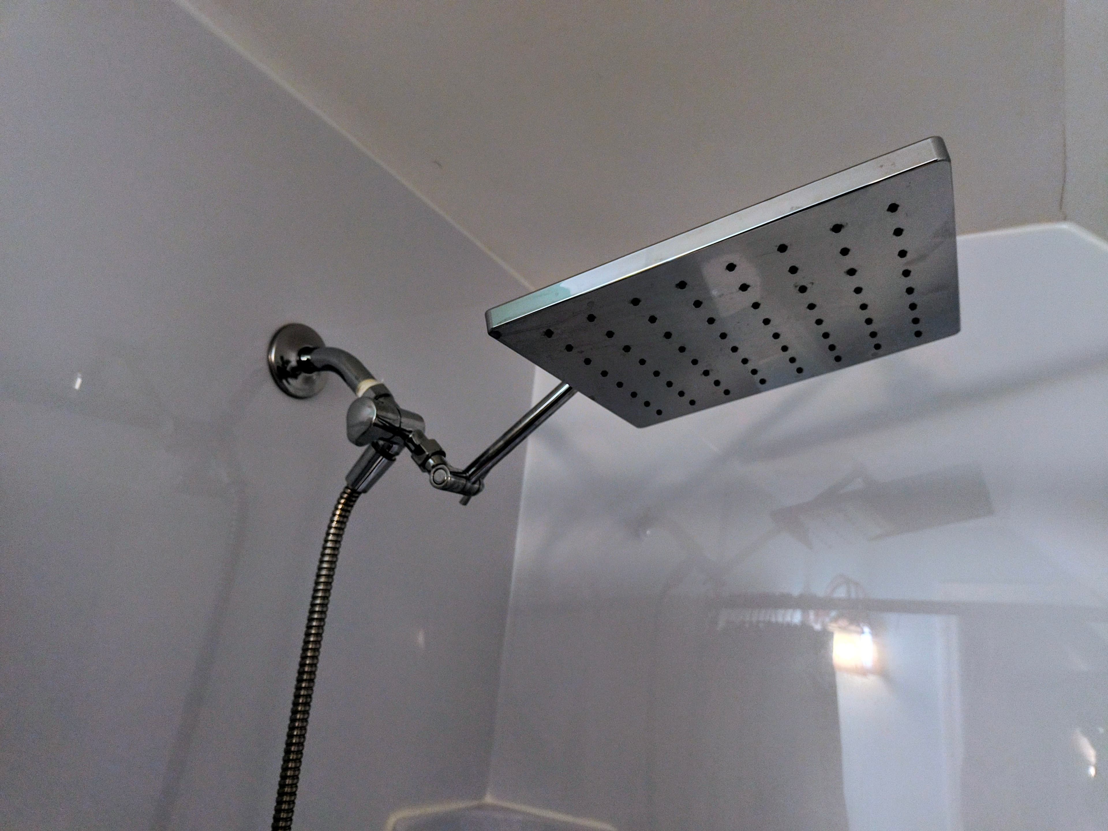 A modern showerhead mounted on a wall.