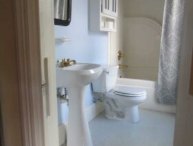 Bathroom in Room 5 featuring pedestal sink and tub-shower combination